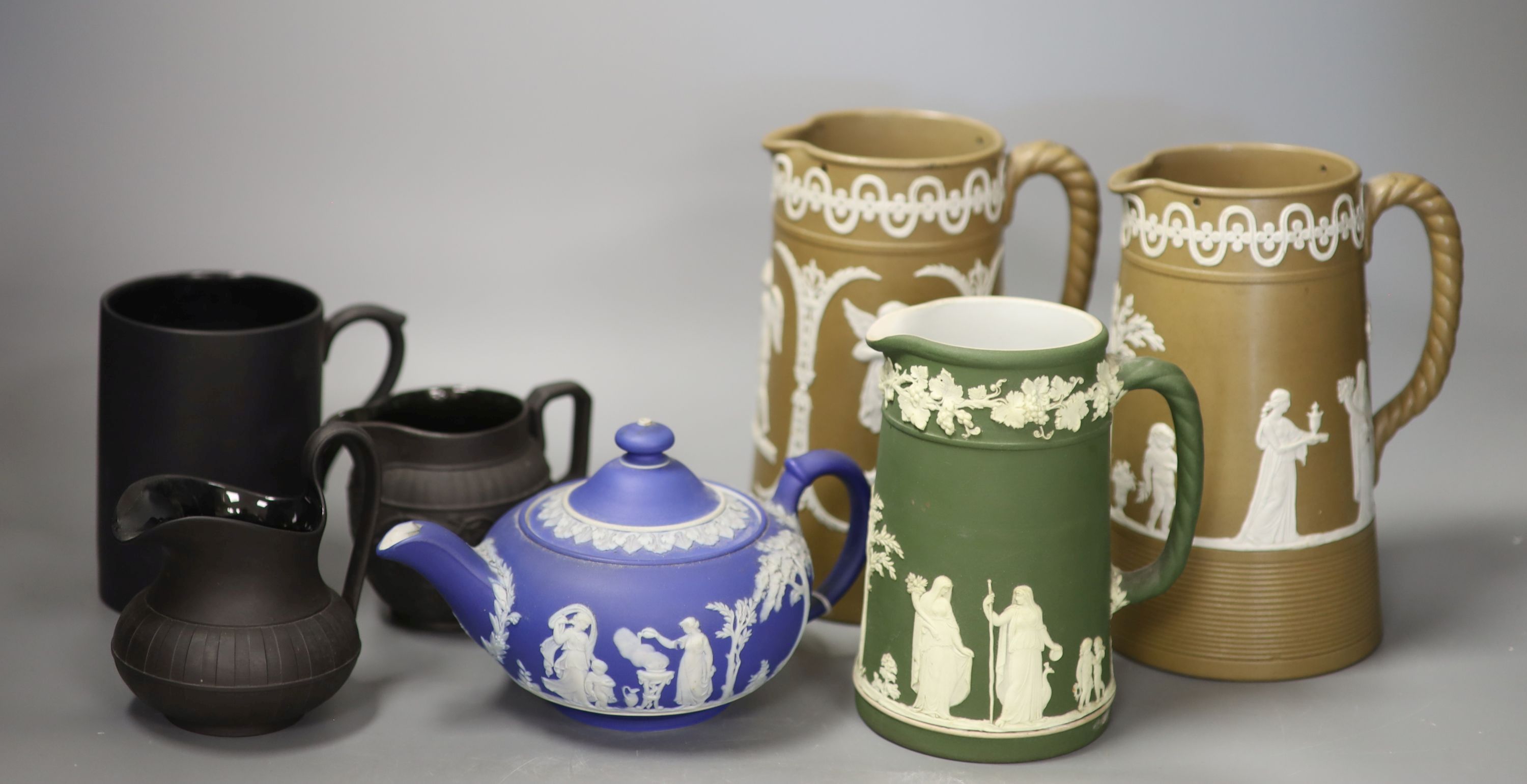 A 19th century Wedgwood teapot and jug, two black basalt jugs and a mug and two drabware jugs, tallest 18cm